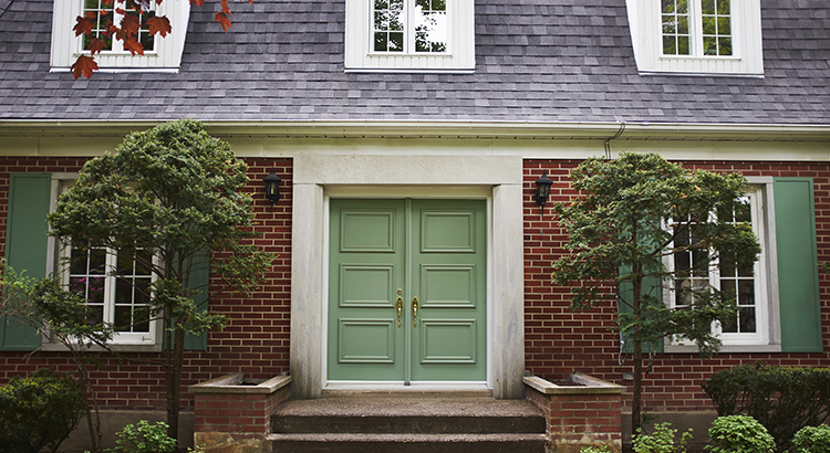 front of a home with green doors